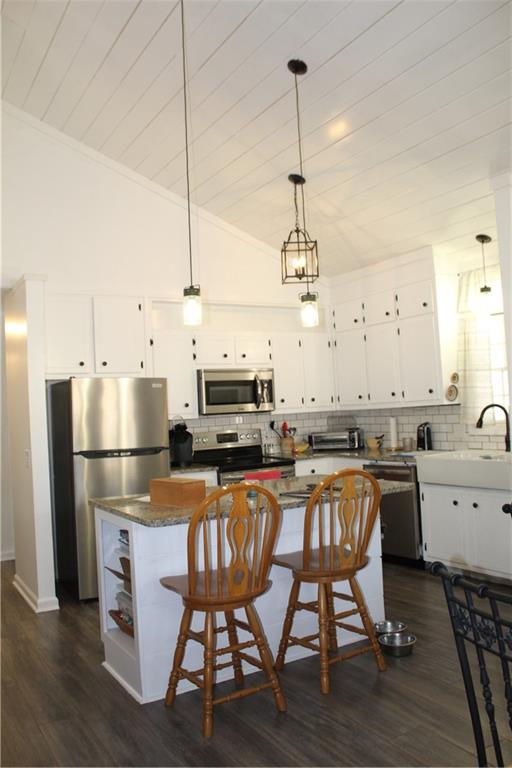 40 Chestatee Springs Road Dahlonega, GA 30533 - Photo 32 of 43 a kitchen with a table chairs appliances and cabinets
