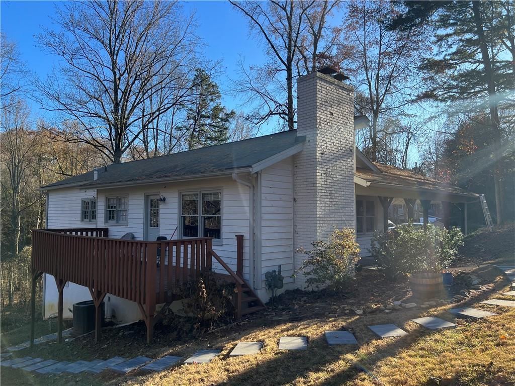 40 Chestatee Springs Road Dahlonega, GA 30533 - Photo 34 of 42 a backyard of a house with table and chairs