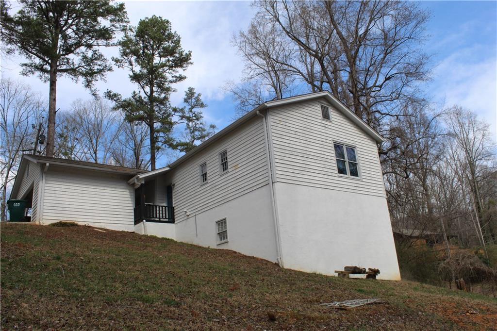 40 Chestatee Springs Road Dahlonega, GA 30533 - Photo 41 of 43 a white house that has a tree in front of it