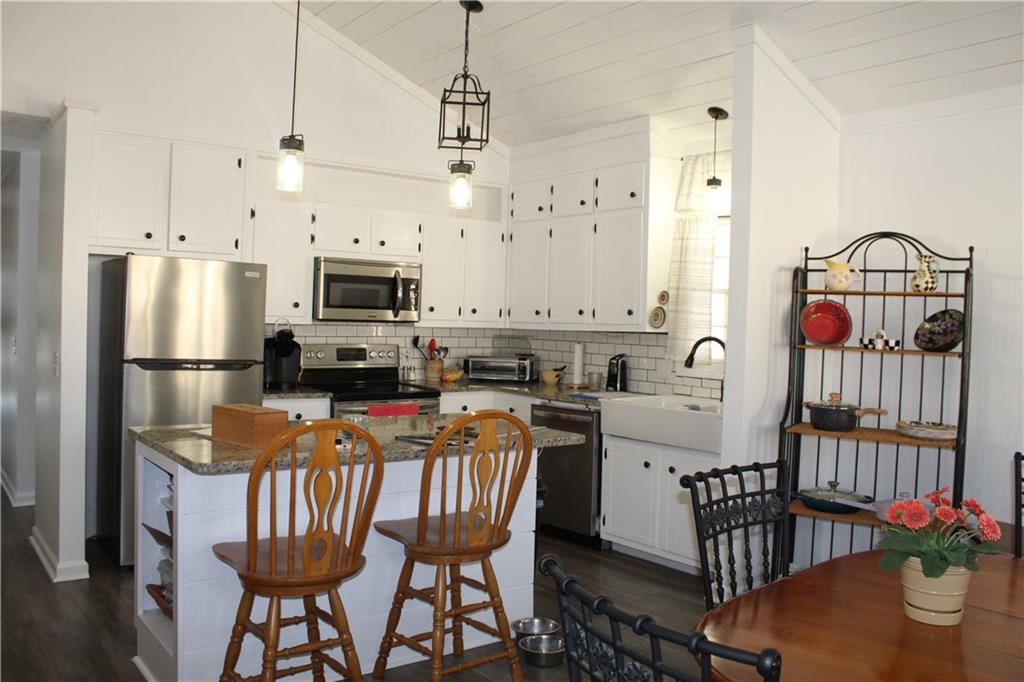 40 Chestatee Springs Road Dahlonega, GA 30533 - Photo 5 of 43 a kitchen with stainless steel appliances granite countertop a stove a refrigerator a kitchen island a dining table and chairs