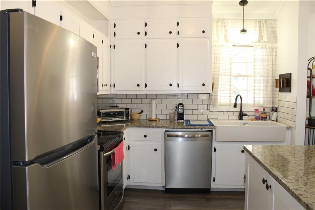 40 Chestatee Springs Road Dahlonega, GA 30533 - Photo 7 of 43 a kitchen with stainless steel appliances granite countertop a sink a stove and a refrigerator