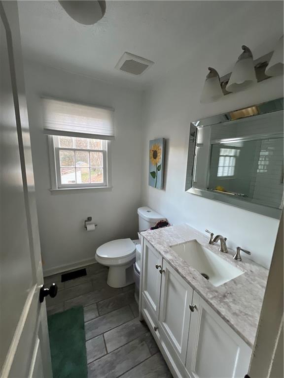 40 Chestatee Springs Road Dahlonega, GA 30533 - Photo 10 of 42 a bathroom with a granite countertop sink toilet and a mirror