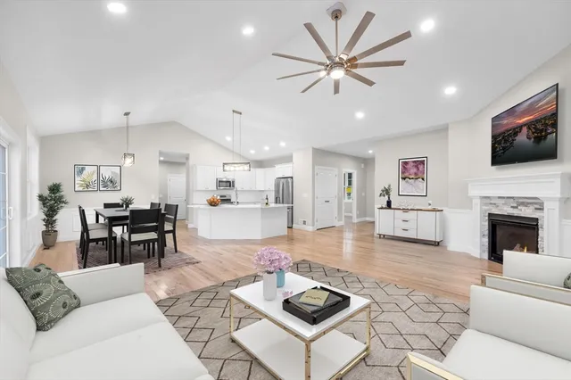 a living room with furniture a fireplace and a flat screen tv