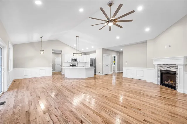 a view of empty room with wooden floor and fireplace