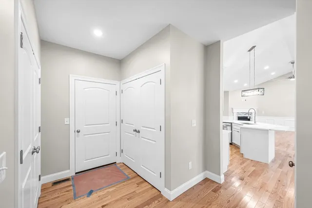 a view of a kitchen with wooden floor and a sink
