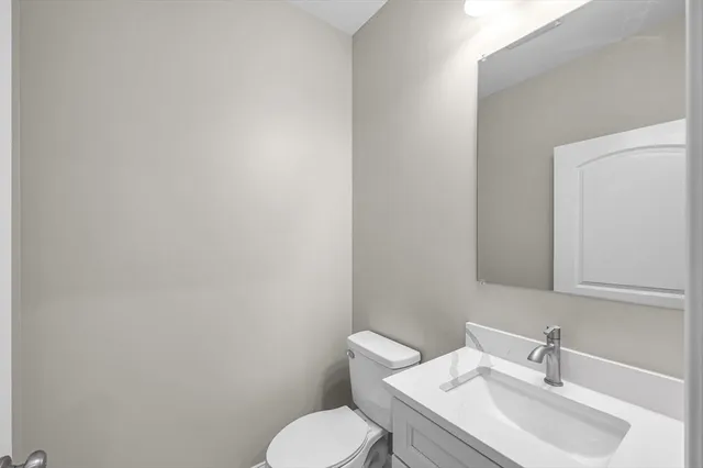 a white toilet sitting next to a bathroom sink