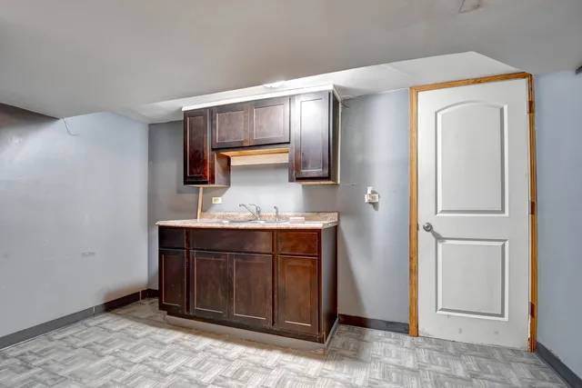 a room with granite countertop a sink and a vanity
