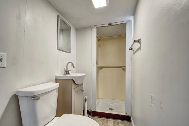 a bathroom with a sink toilet and shower