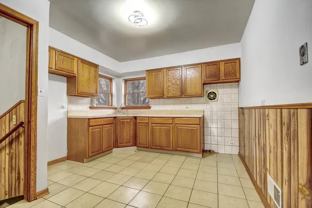 a kitchen with a sink a stove top oven and cabinets