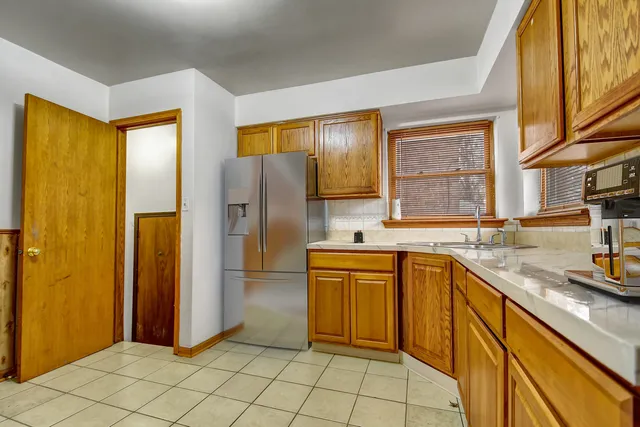 a kitchen with stainless steel appliances granite countertop a refrigerator and a sink