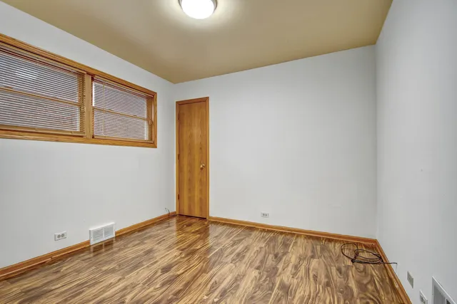 a view of an empty room and wooden floor