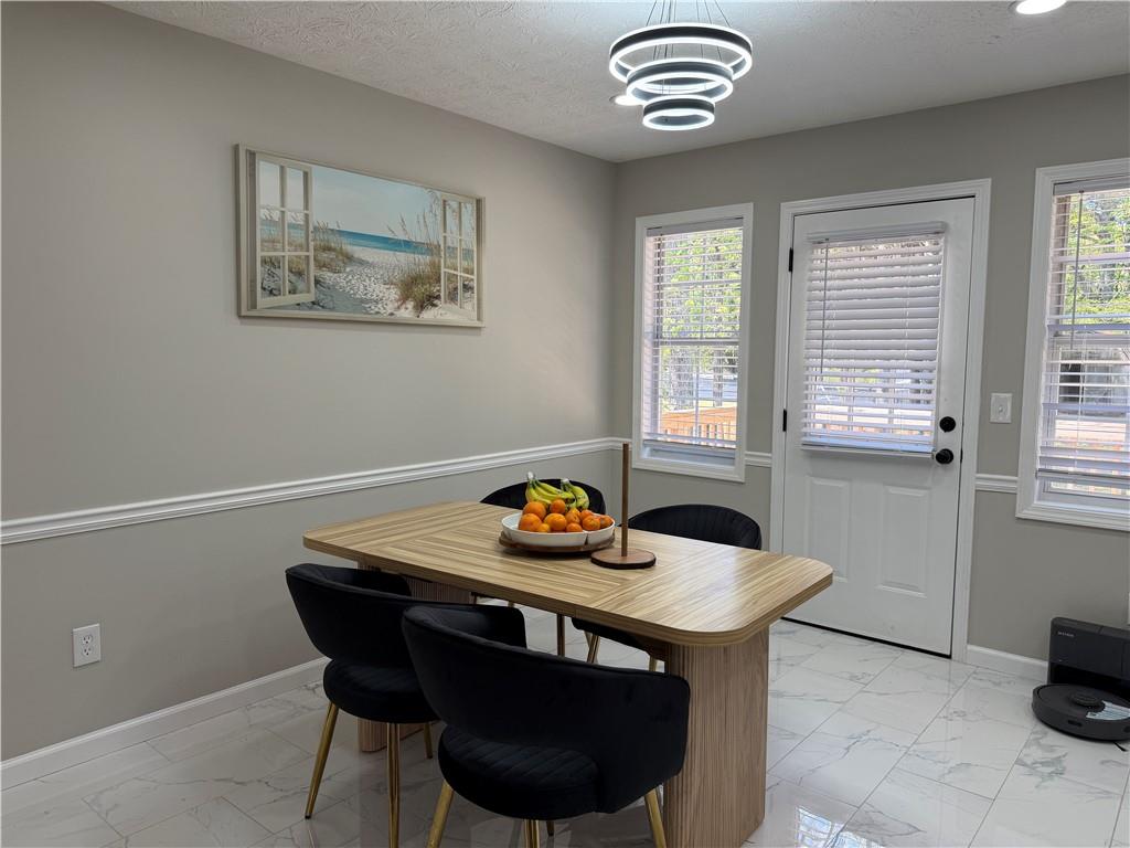 934 Bay Ridge Drive Lawrenceville, GA 30045 - Photo 28 of 78 a view of a dining room with furniture and window