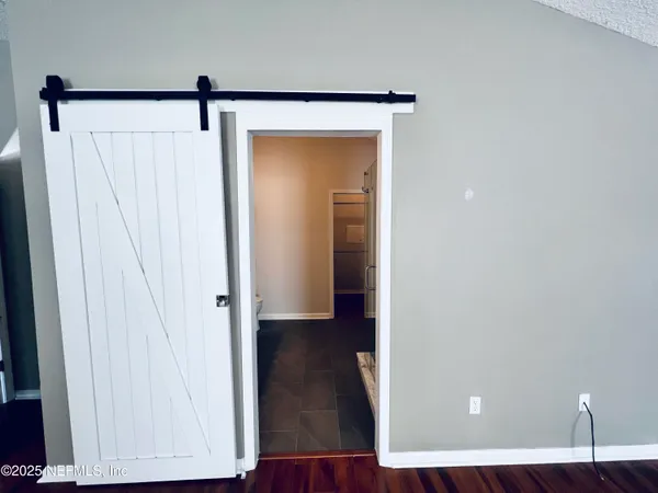 a view of a hallway with wooden floor