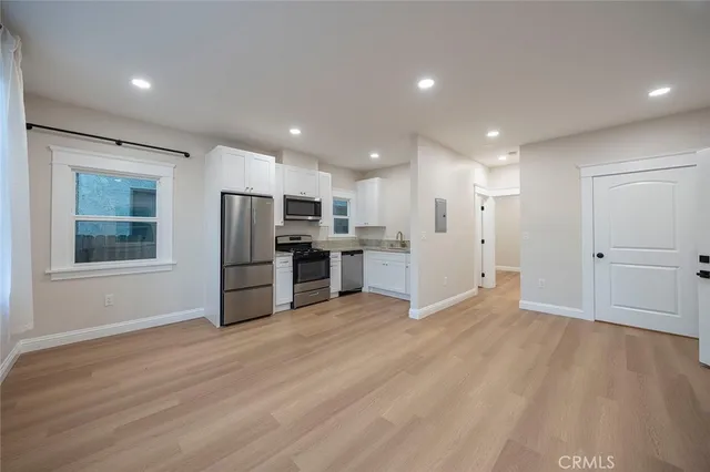 a view of kitchen with stainless steel appliances refrigerator oven and microwave