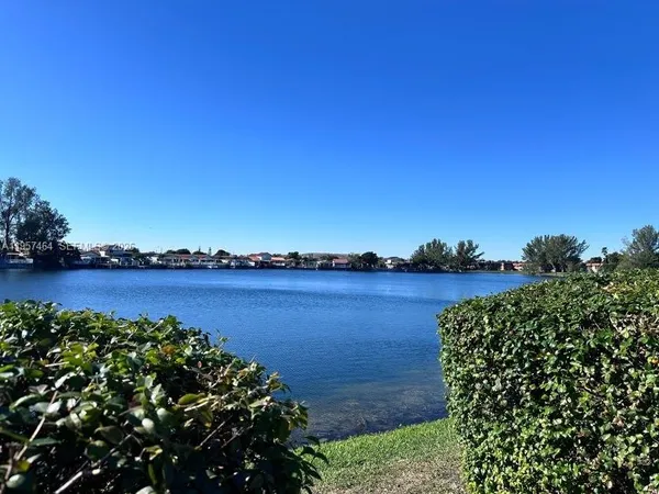 a view of a lake with a house in the background