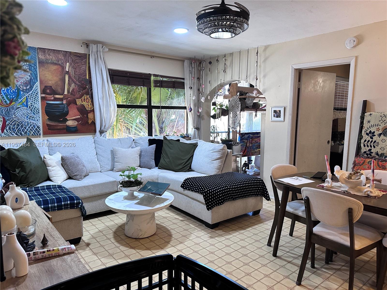 2480 West 67th Place, Unit 2312 Hialeah, FL 33016 - Photo 13 of 16 a living room with furniture and a large window