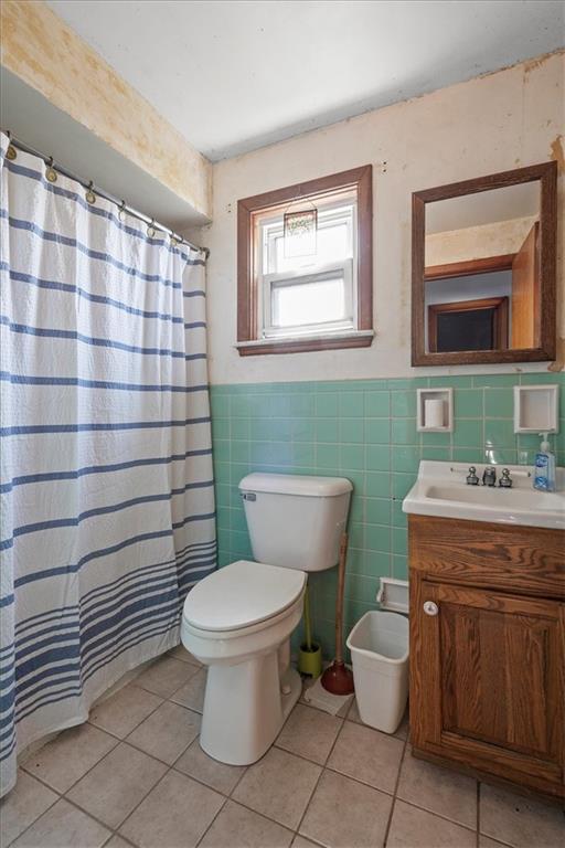 1105 15th Street McKees Rocks, PA 15136 - Photo 13 of 17 a bathroom with a granite countertop toilet a sink and a mirror