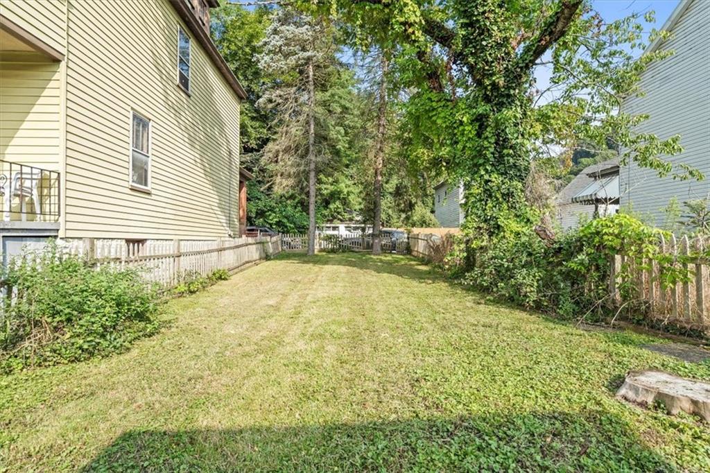 1105 15th Street McKees Rocks, PA 15136 - Photo 15 of 17 a view of a backyard with plants and large trees