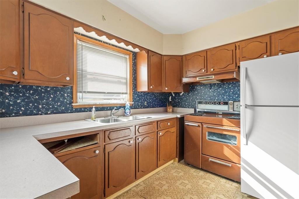 1105 15th Street McKees Rocks, PA 15136 - Photo 8 of 17 a kitchen with a sink stove and cabinets