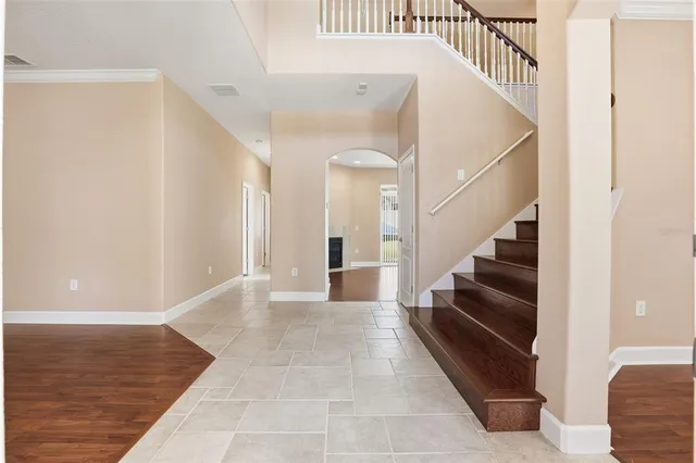 a view of entryway and hall with wooden floor