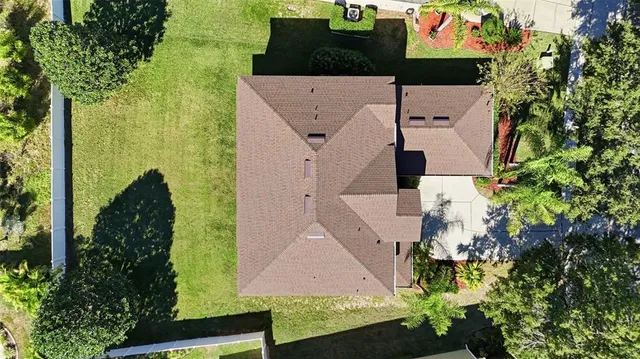 an aerial view of a house with a yard