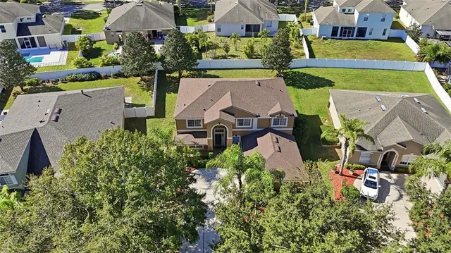 an aerial view of multiple houses with yard