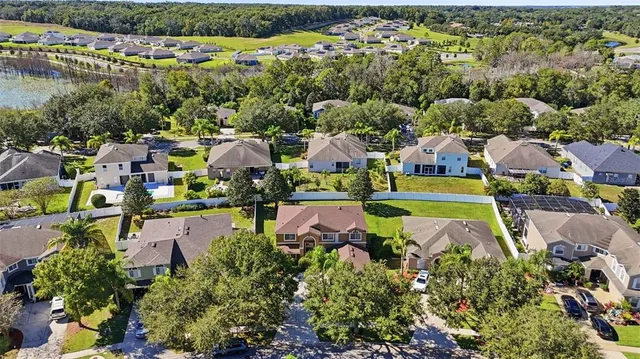 an aerial view of a houses with a swimming pool