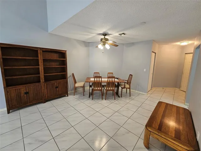 a view of a fountain in a yard with palm trees