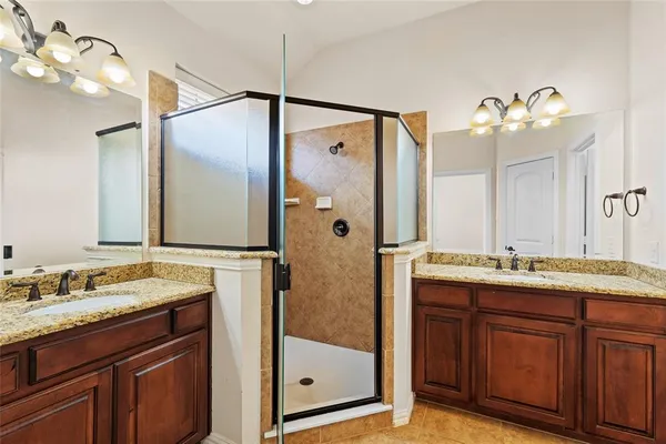 a bathroom with a granite countertop sink mirror and double