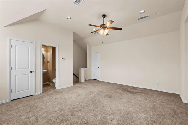 an empty room with closet and a chandelier fan