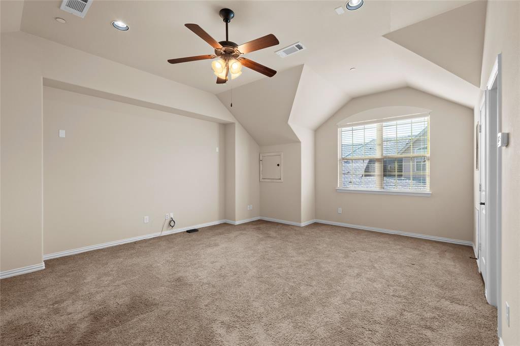 6465 Naples Drive Irving, TX 75039 - Photo 18 of 25 an empty room with windows and fan