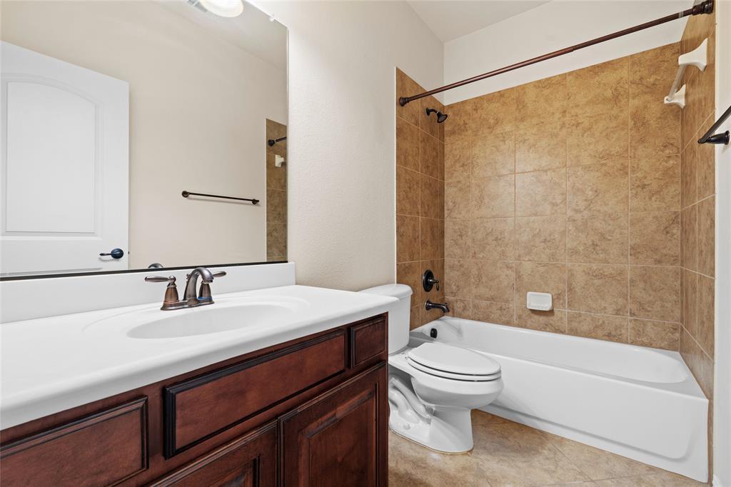 6465 Naples Drive Irving, TX 75039 - Photo 23 of 25 a bathroom with a sink a toilet and a bathtub