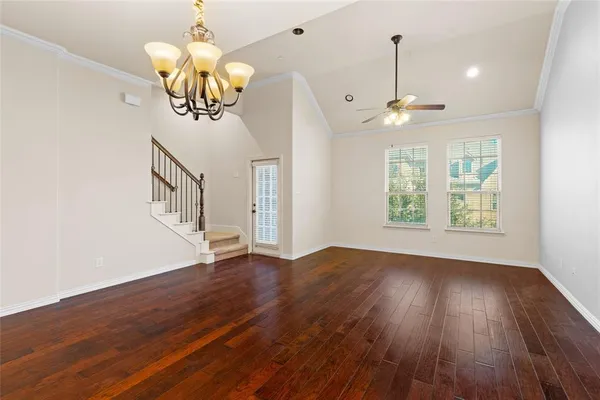 a view of a room with wooden floor and window