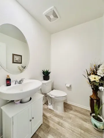 a bathroom with a sink toilet and a mirror