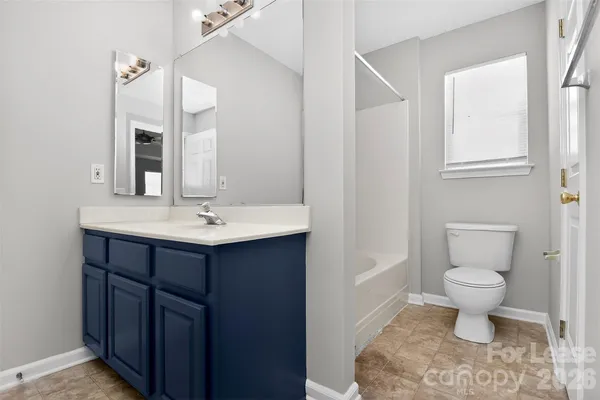 a bathroom with a sink toilet a mirror and vanity