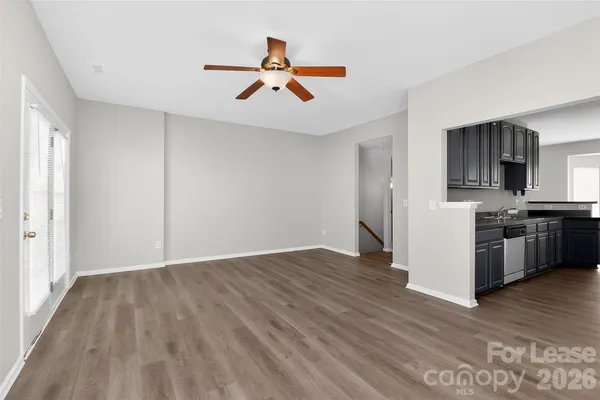 a view of a kitchen with a sink stove fridge and wooden floor