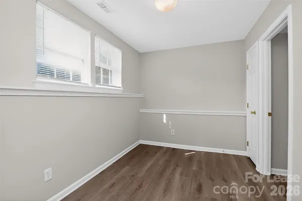 a view of a room with wooden floor and window