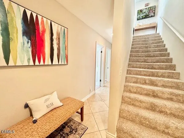 a view of a hallway with wooden floor and couch