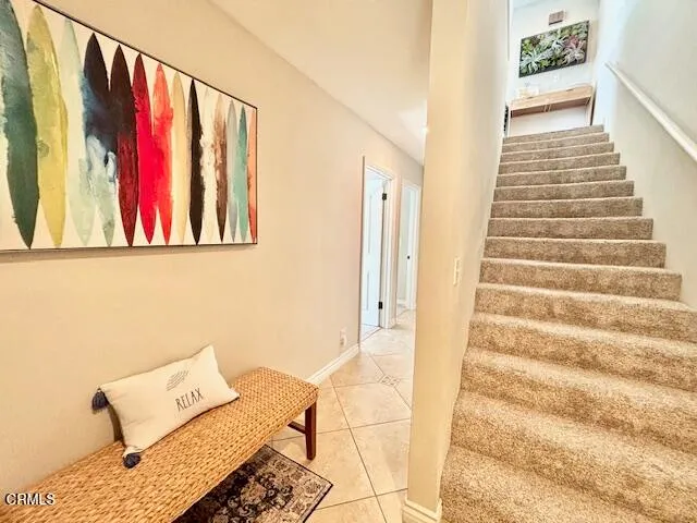 a view of a hallway with wooden floor and couch