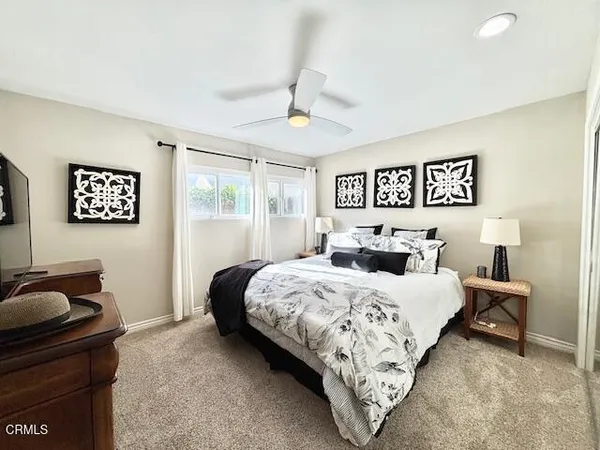 a bedroom with bed and a couch