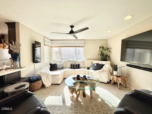 a living room with furniture wooden floor and a flat screen tv