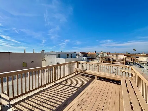a view of balcony with wooden floor and city view