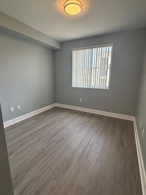 2401 Renaissance Way Boynton Beach, FL 33426 - Photo 18 of 21 a view of an empty room with wooden floor and a window