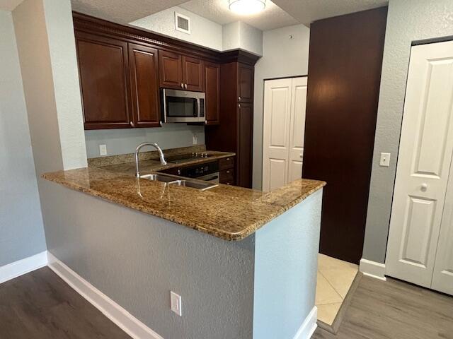2401 Renaissance Way Boynton Beach, FL 33426 - Photo 7 of 21 a kitchen with granite countertop cabinets and steel stainless steel appliances