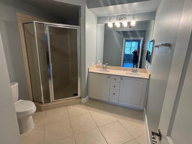 2401 Renaissance Way Boynton Beach, FL 33426 - Photo 10 of 21 a spacious bathroom with a mirror a toilet a sink and a shower