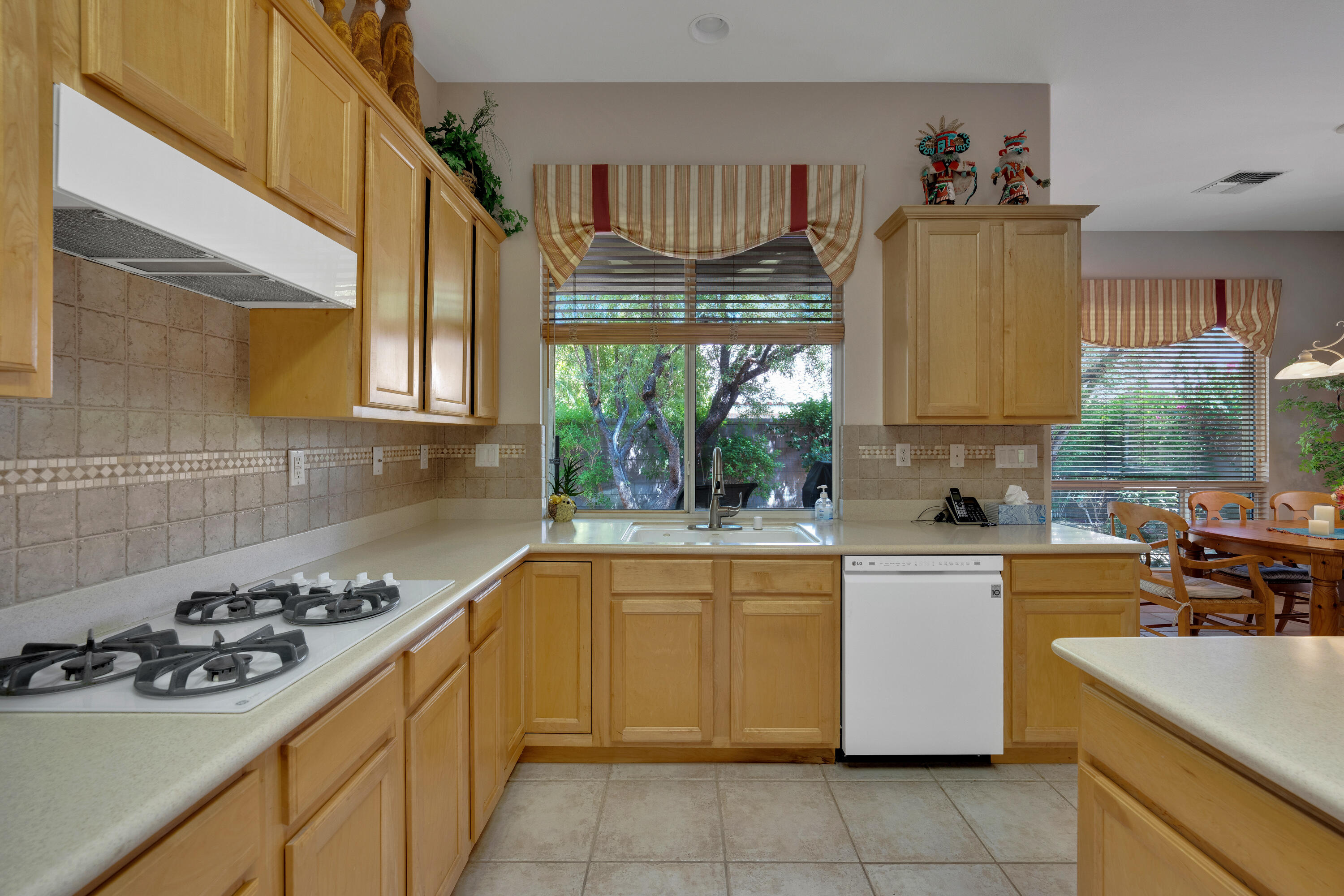 37384 Wyndham Road Palm Desert, CA 92211 - Photo 16 of 30 a kitchen with a sink a stove and a refrigerator