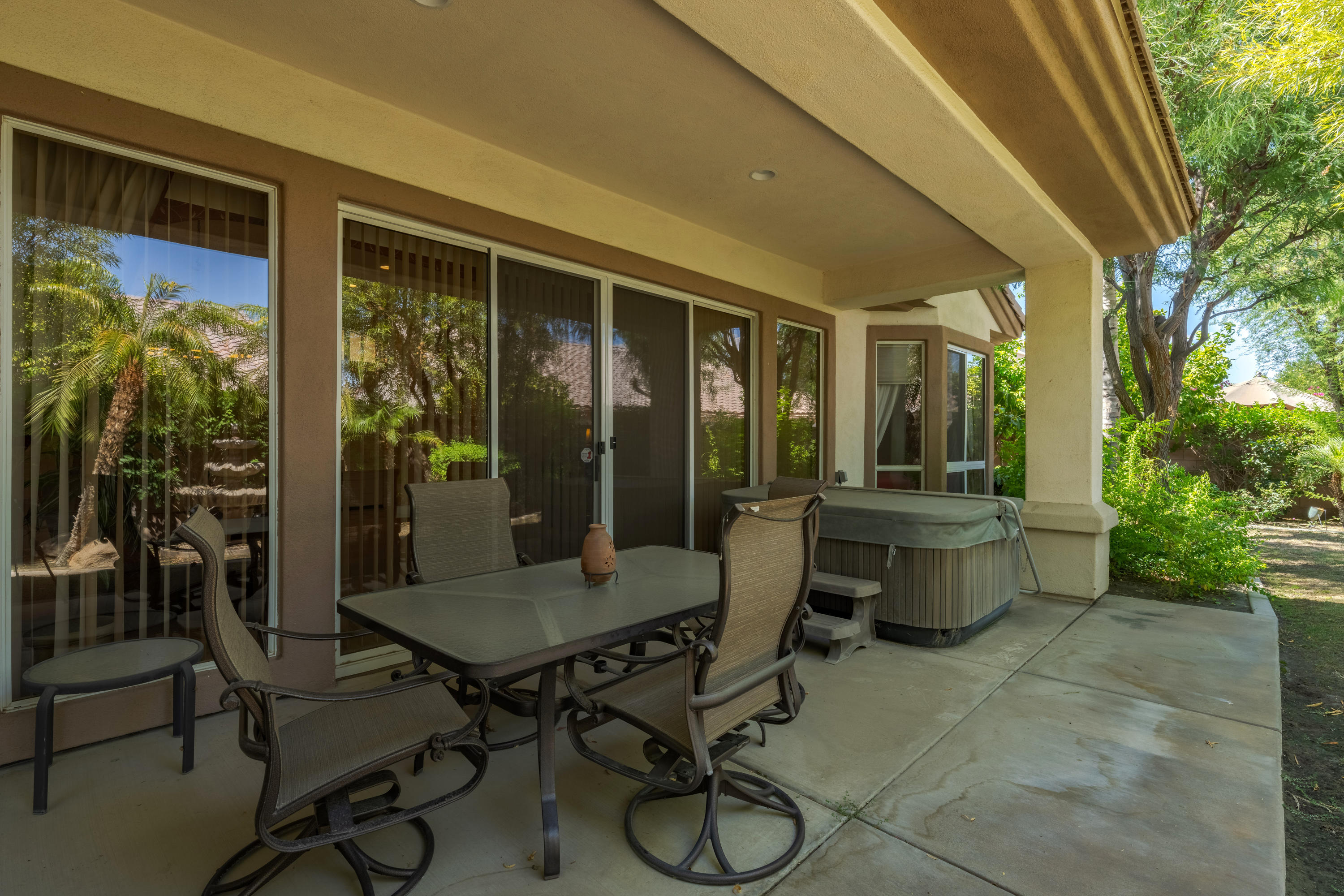 37384 Wyndham Road Palm Desert, CA 92211 - Photo 3 of 30 a view of a patio with table and chairs and potted plants