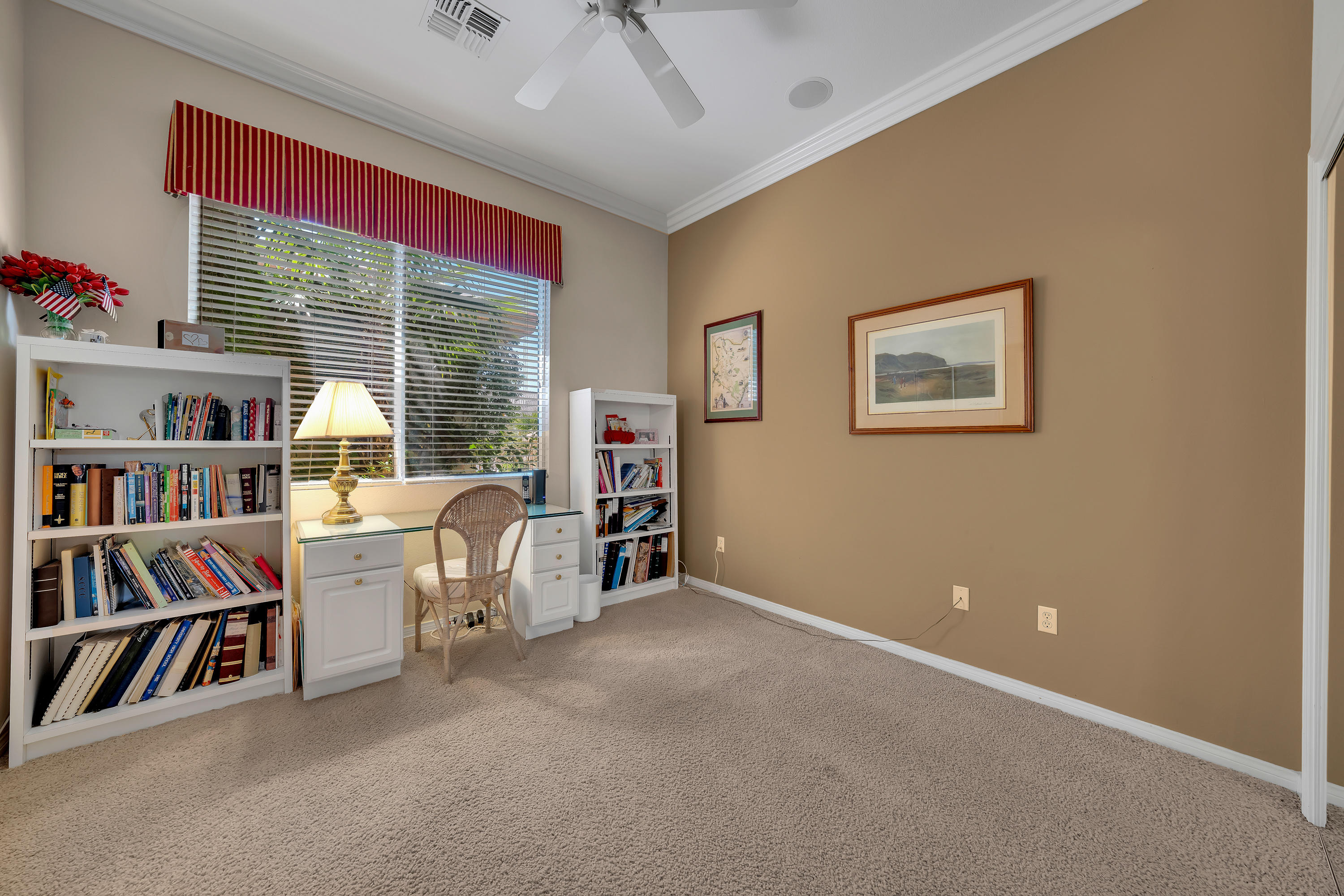 37384 Wyndham Road Palm Desert, CA 92211 - Photo 27 of 30 a view of a workspace with furniture and a book shelf