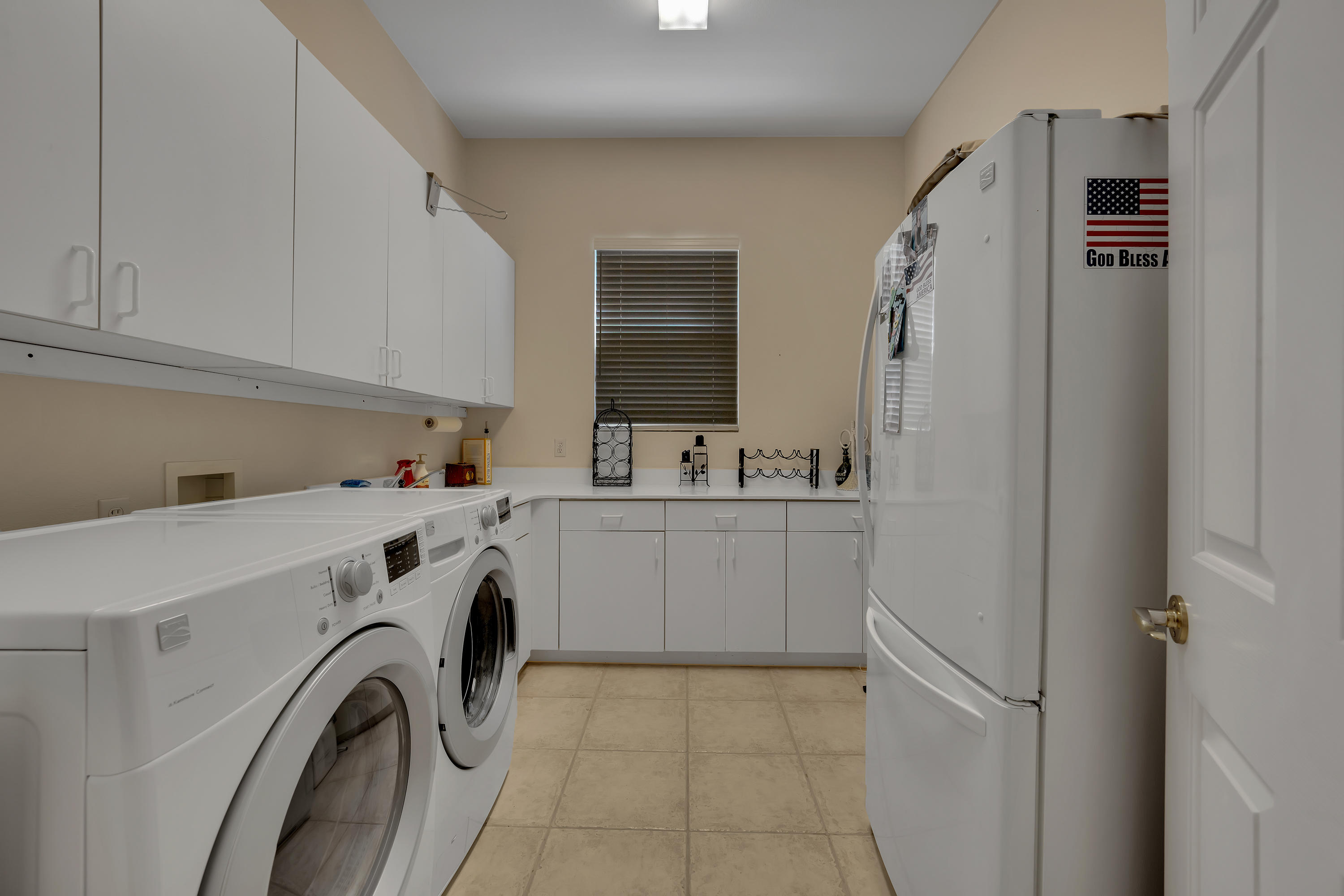 37384 Wyndham Road Palm Desert, CA 92211 - Photo 29 of 30 a utility room with cabinets washer and dryer