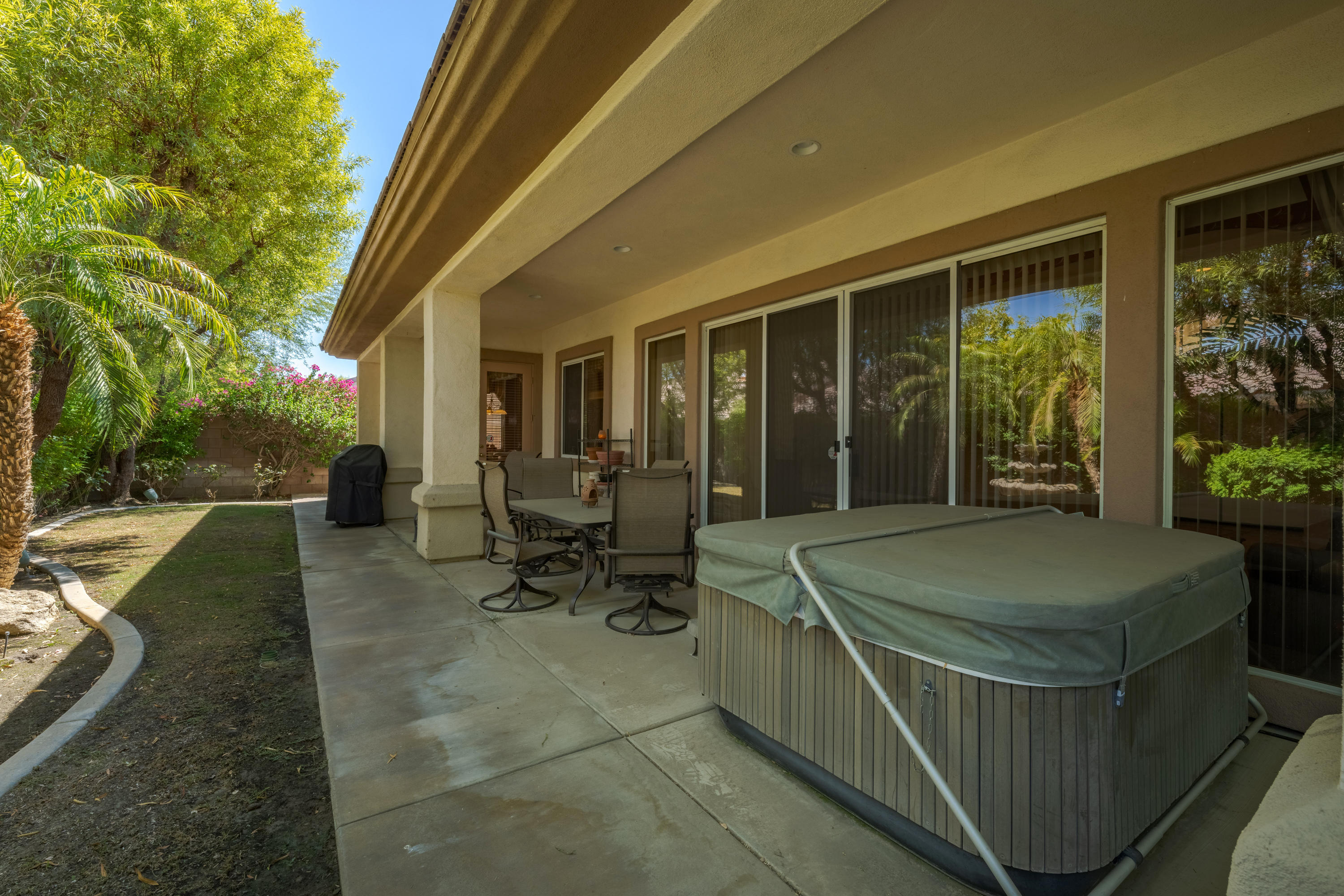 37384 Wyndham Road Palm Desert, CA 92211 - Photo 4 of 30 a dinning table and chairs in the patio in front of a house